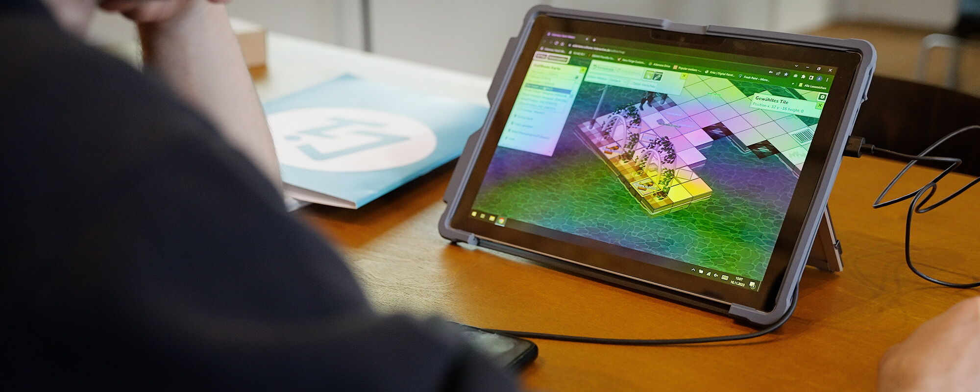 Person playing Adamara on a tablet